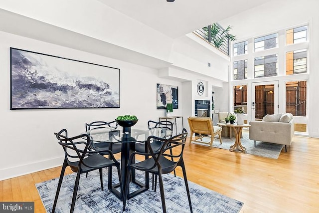 dining area featuring hardwood / wood-style floors and a high ceiling