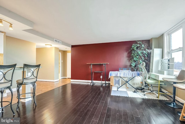 sitting room with wood-type flooring