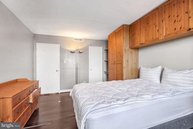 bedroom featuring dark hardwood / wood-style floors and a closet