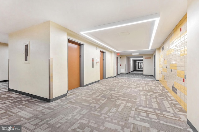 corridor featuring carpet flooring and elevator