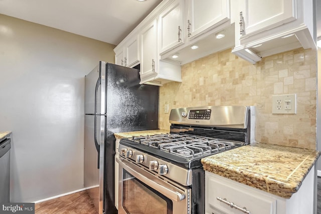 kitchen featuring white cabinetry, light stone counters, tasteful backsplash, and stainless steel appliances