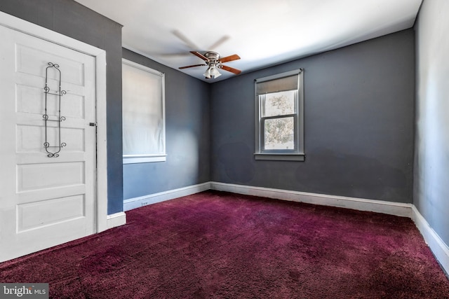 spare room featuring ceiling fan and carpet