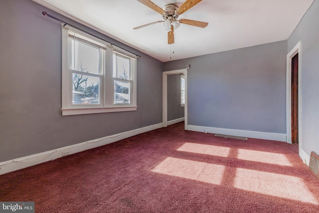 spare room featuring ceiling fan and carpet flooring