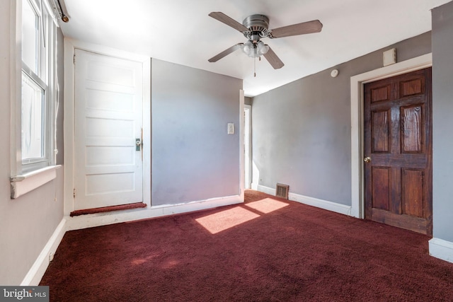 carpeted spare room with ceiling fan