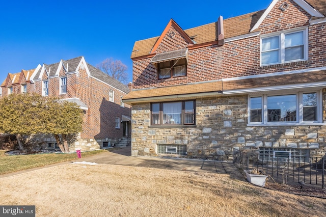 rear view of property with a lawn