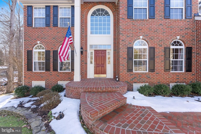 view of snow covered property entrance