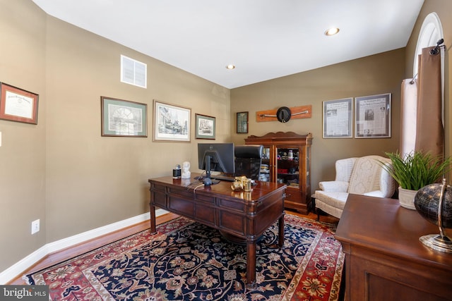 office space with wood-type flooring