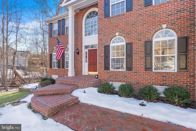 view of snow covered property entrance