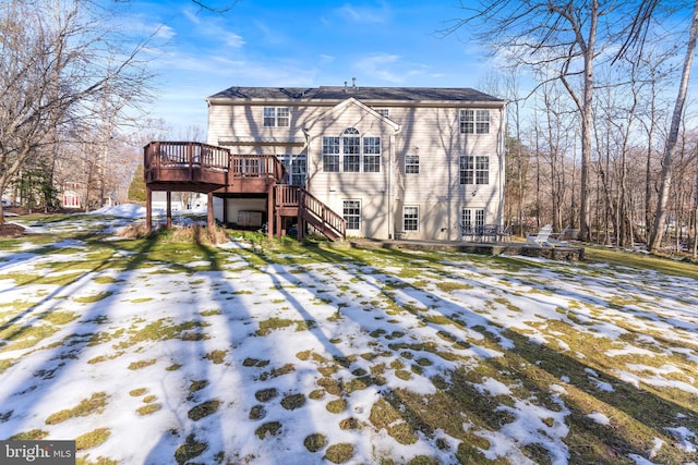 snow covered house featuring a deck