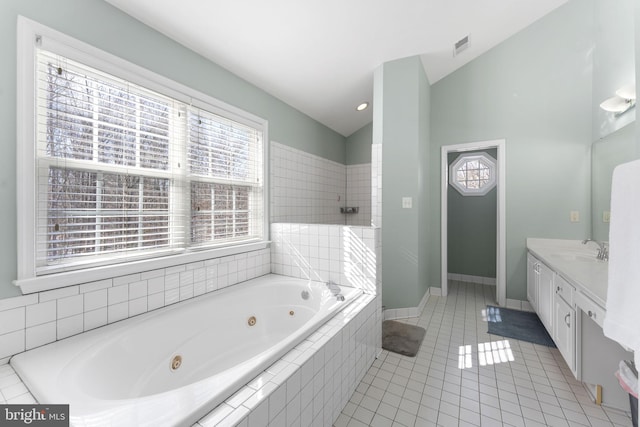 bathroom featuring tile patterned floors, lofted ceiling, separate shower and tub, and vanity