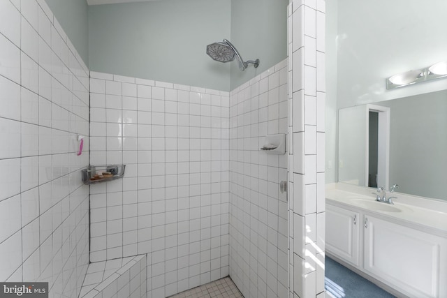 bathroom with vanity and tiled shower