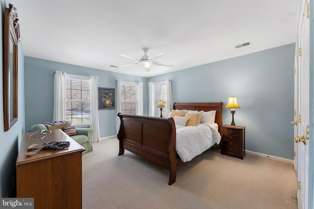 bedroom featuring ceiling fan and light carpet