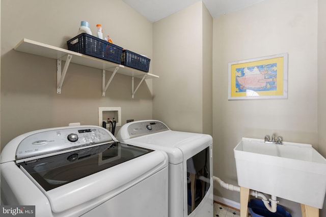 laundry area featuring washer and clothes dryer and sink