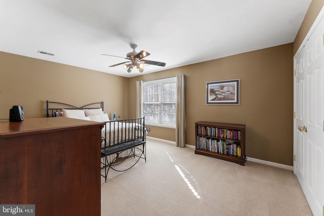 carpeted bedroom with a closet and ceiling fan