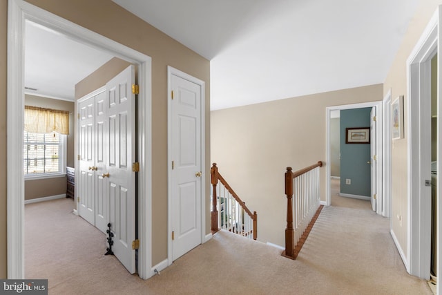 hallway with light colored carpet