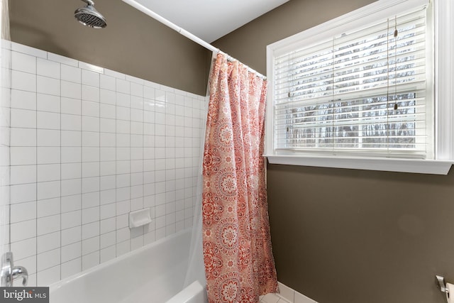 bathroom featuring shower / bathtub combination with curtain and a healthy amount of sunlight