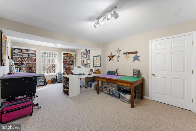 carpeted home office featuring rail lighting