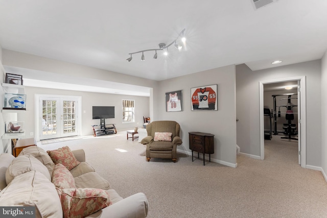 carpeted living room with rail lighting