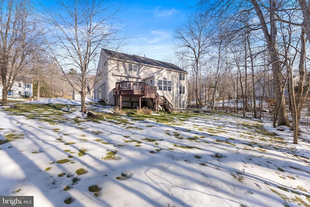 snow covered house with a deck