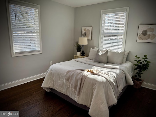 bedroom with dark hardwood / wood-style floors