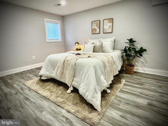 bedroom featuring dark hardwood / wood-style flooring