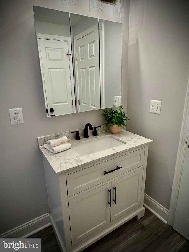 bathroom with hardwood / wood-style flooring and vanity