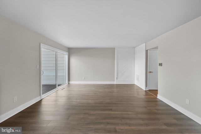 unfurnished room with dark hardwood / wood-style floors