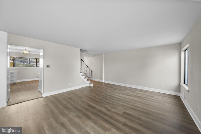 unfurnished living room with dark hardwood / wood-style floors