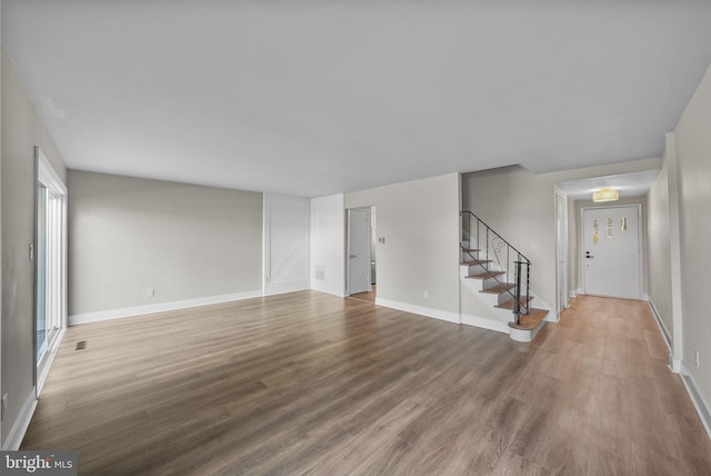 unfurnished living room featuring wood-type flooring