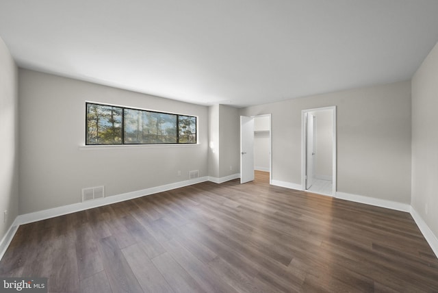 unfurnished bedroom featuring dark hardwood / wood-style floors and a closet