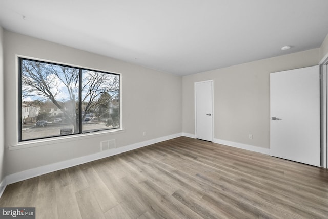 unfurnished room with light hardwood / wood-style flooring