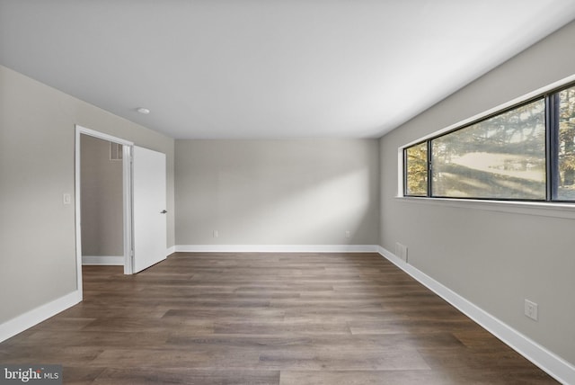 spare room with dark wood-type flooring