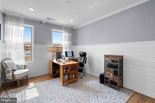 office space featuring crown molding, plenty of natural light, and light hardwood / wood-style flooring