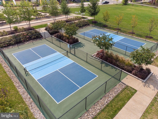 view of tennis court featuring a lawn