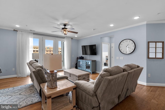 living room with crown molding, hardwood / wood-style flooring, and ceiling fan