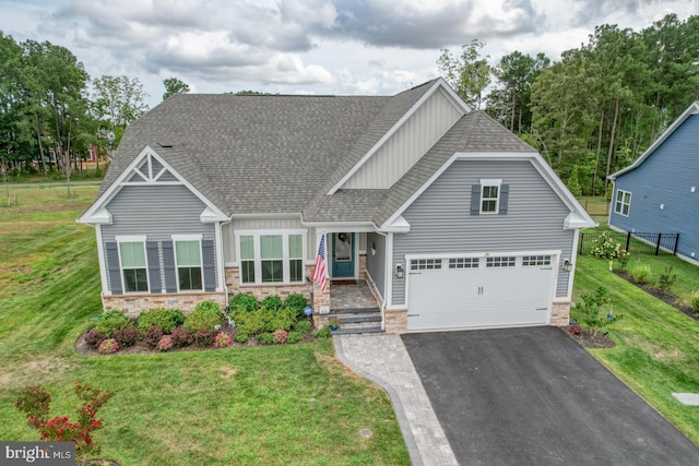 craftsman-style house featuring a garage and a front lawn