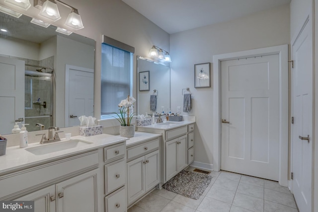 bathroom with vanity, a shower with door, and tile patterned flooring