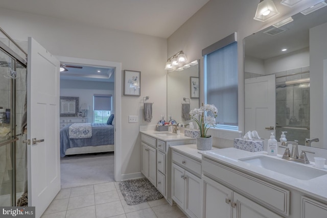 bathroom with a shower with door, vanity, tile patterned floors, and ceiling fan