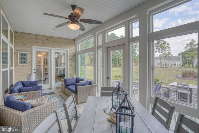 sunroom featuring ceiling fan and a healthy amount of sunlight