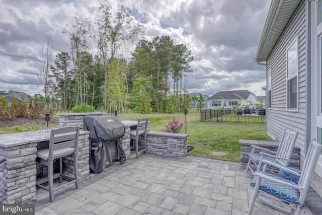 view of patio / terrace with area for grilling and an outdoor bar