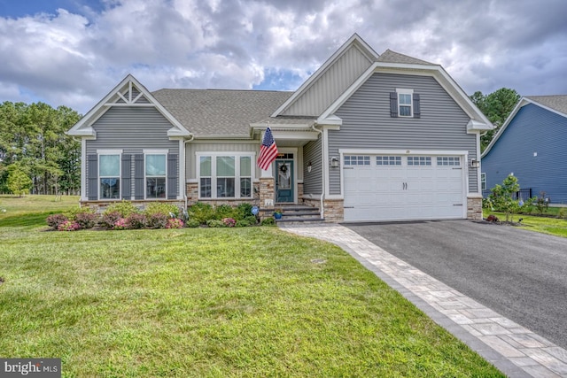 craftsman house featuring a garage and a front yard