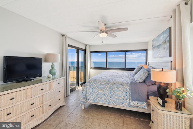 tiled bedroom featuring a water view, ceiling fan, and access to outside