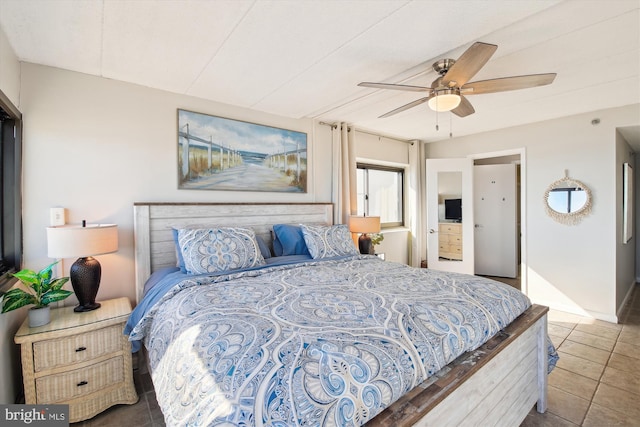 bedroom featuring dark tile patterned flooring and ceiling fan