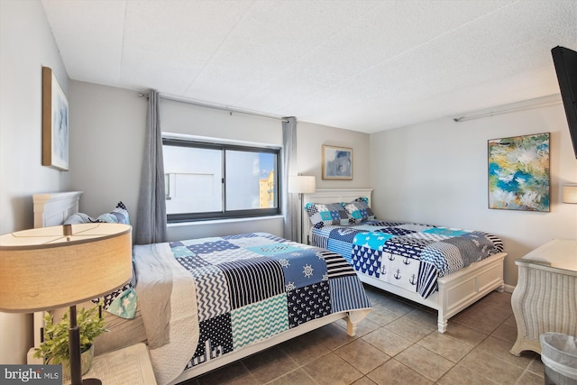 bedroom featuring tile patterned floors and a textured ceiling