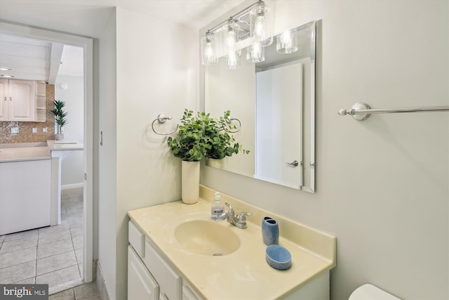 bathroom featuring tasteful backsplash, vanity, and tile patterned flooring