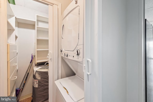 laundry area featuring stacked washing maching and dryer