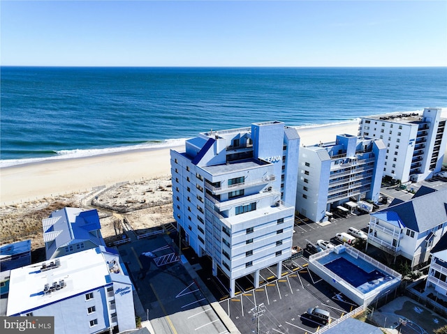 drone / aerial view with a water view and a beach view