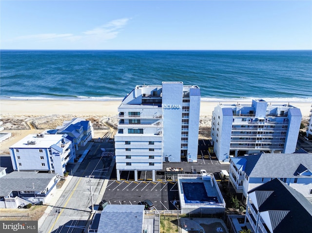 bird's eye view featuring a view of the beach and a water view