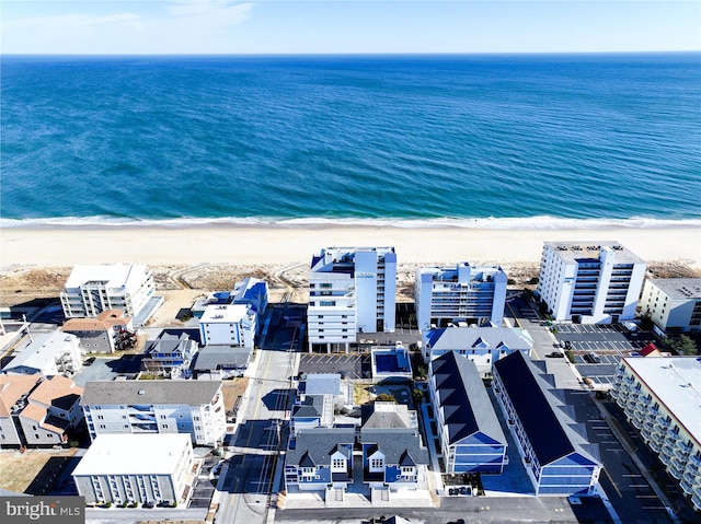 birds eye view of property featuring a water view and a beach view