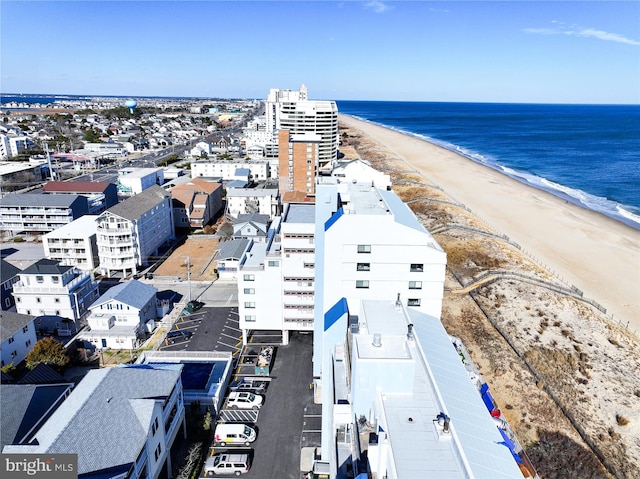 drone / aerial view featuring a water view and a beach view